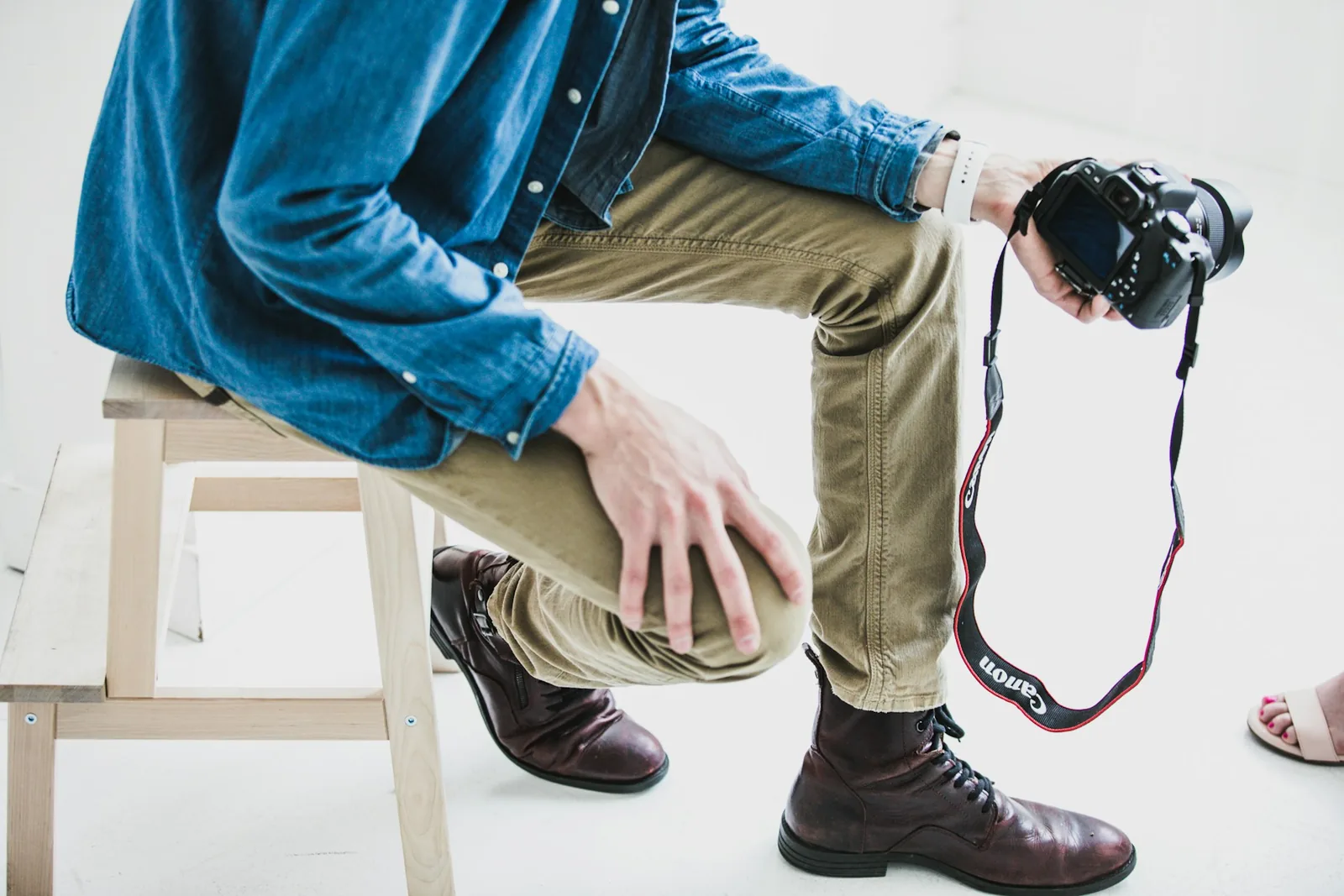 person holding a camera: How To Take Pictures Of Clothes To Sell Online