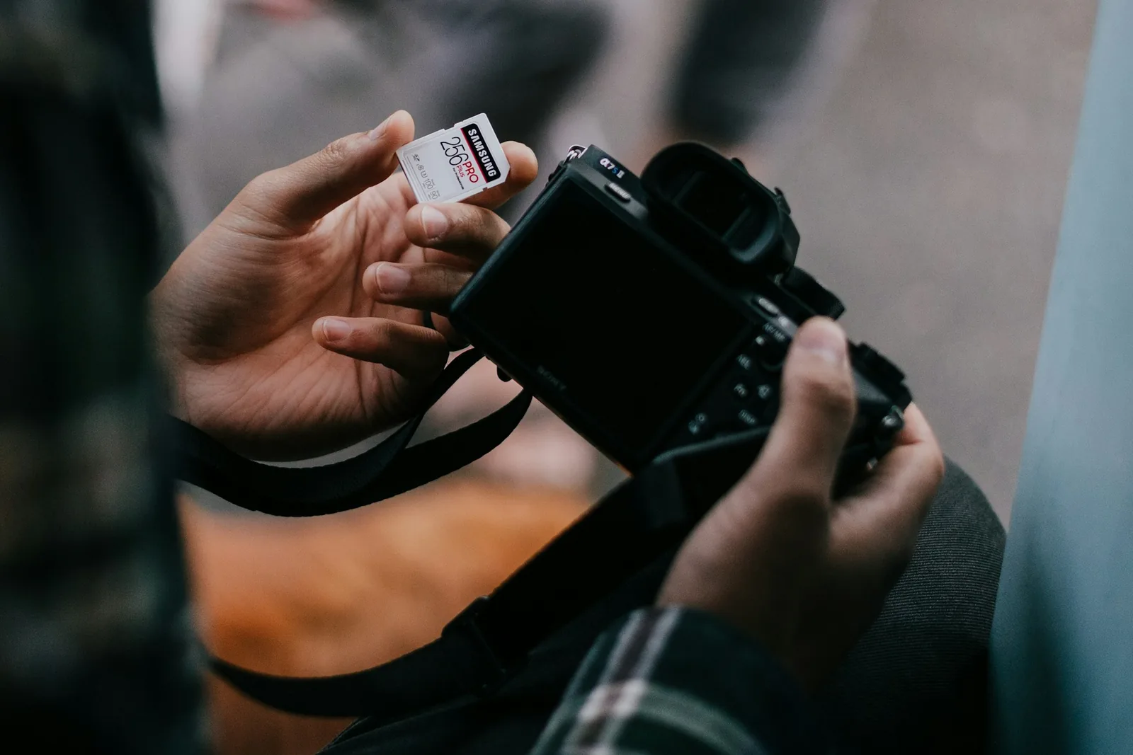 man adding memory card: Best Camera For Product Photography