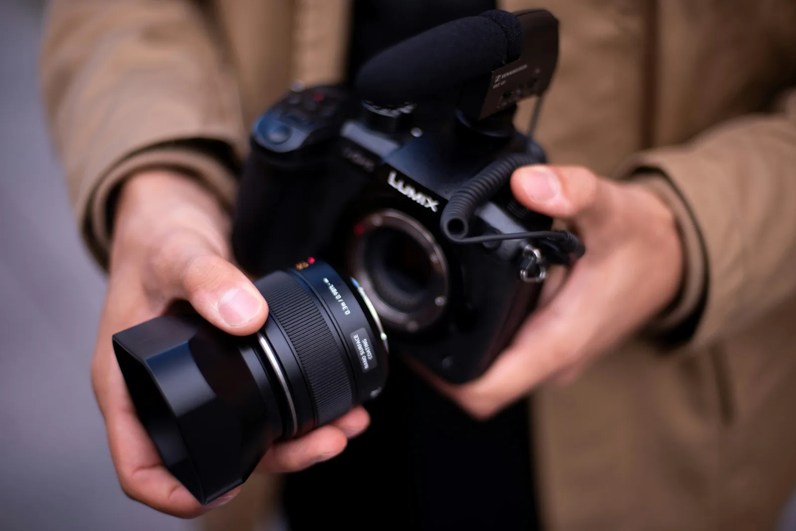 Man Holding Camera: Best Lens for Jewelry Photography