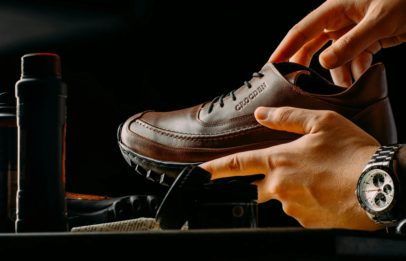 person holding a shoe: Shoe Product Photography