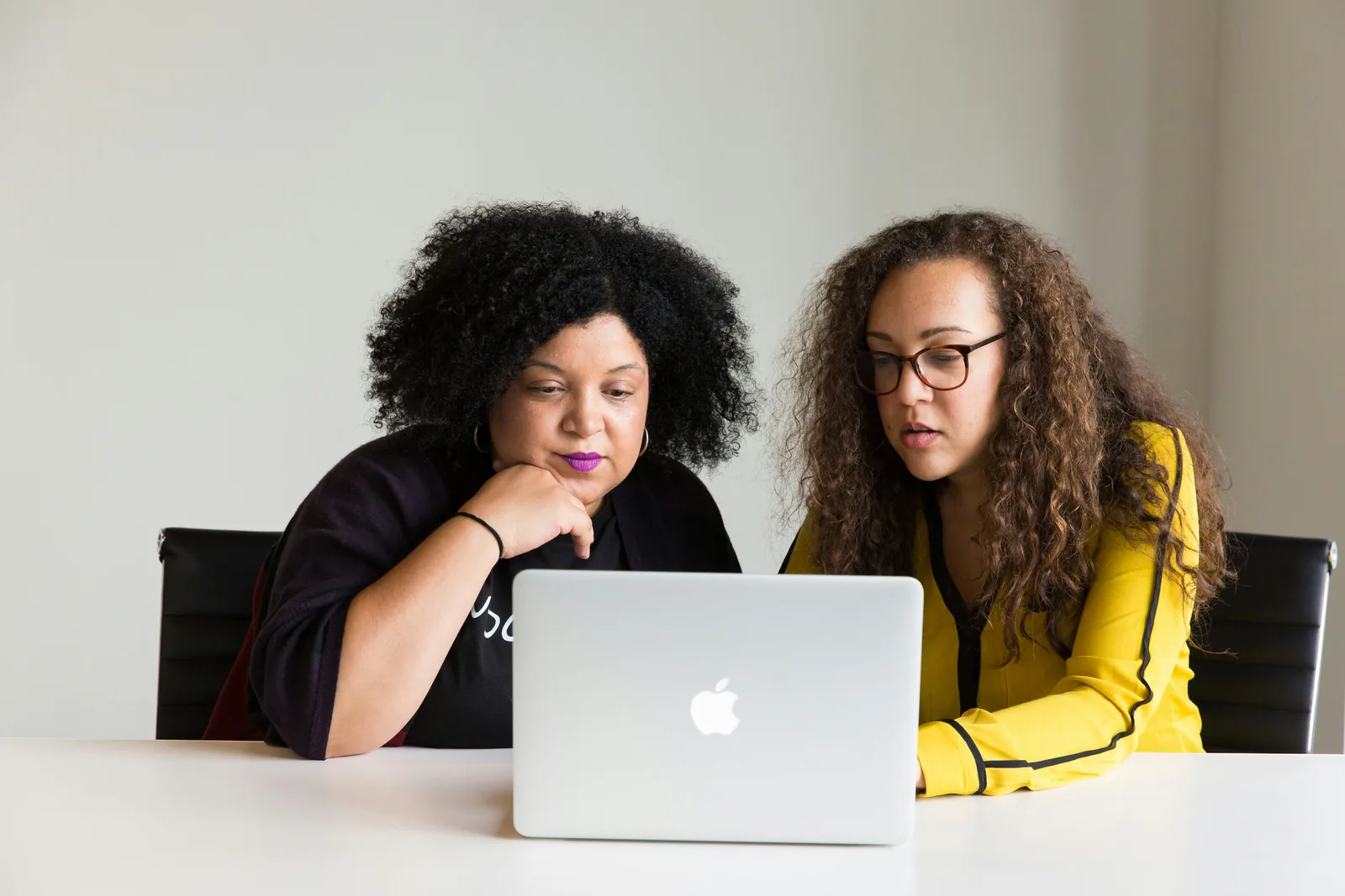 two woman working together: AI Photoshoot