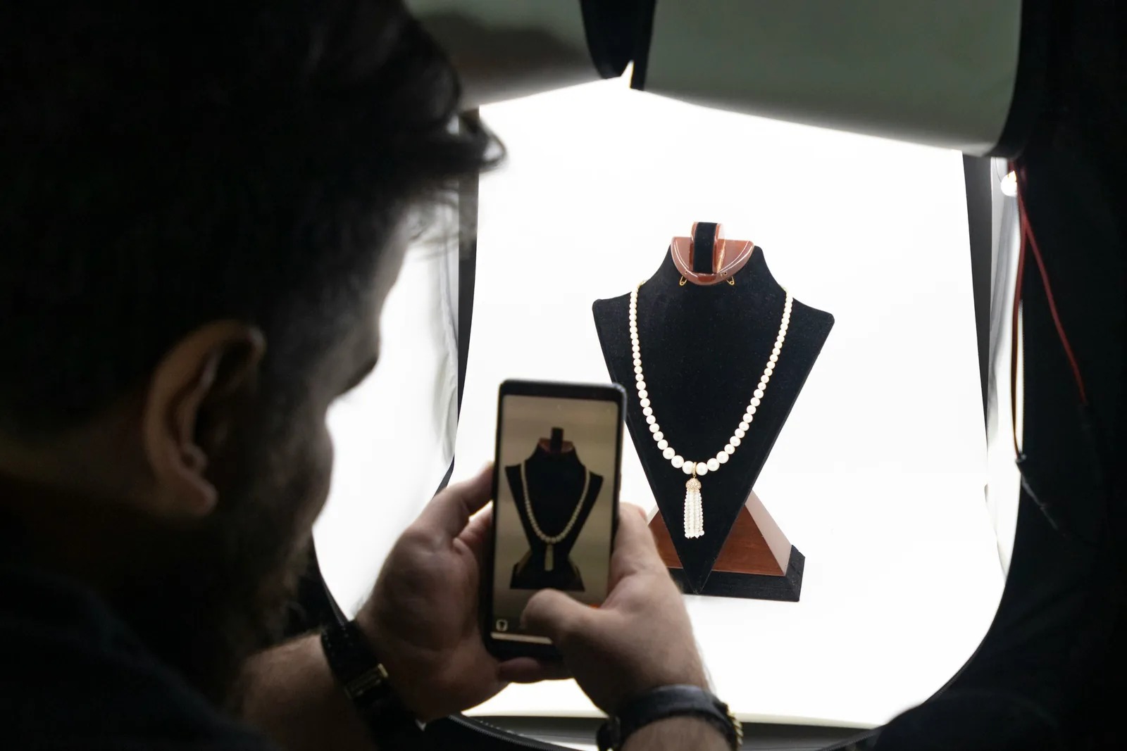 person taking a photo: Background for Jewellery Photography